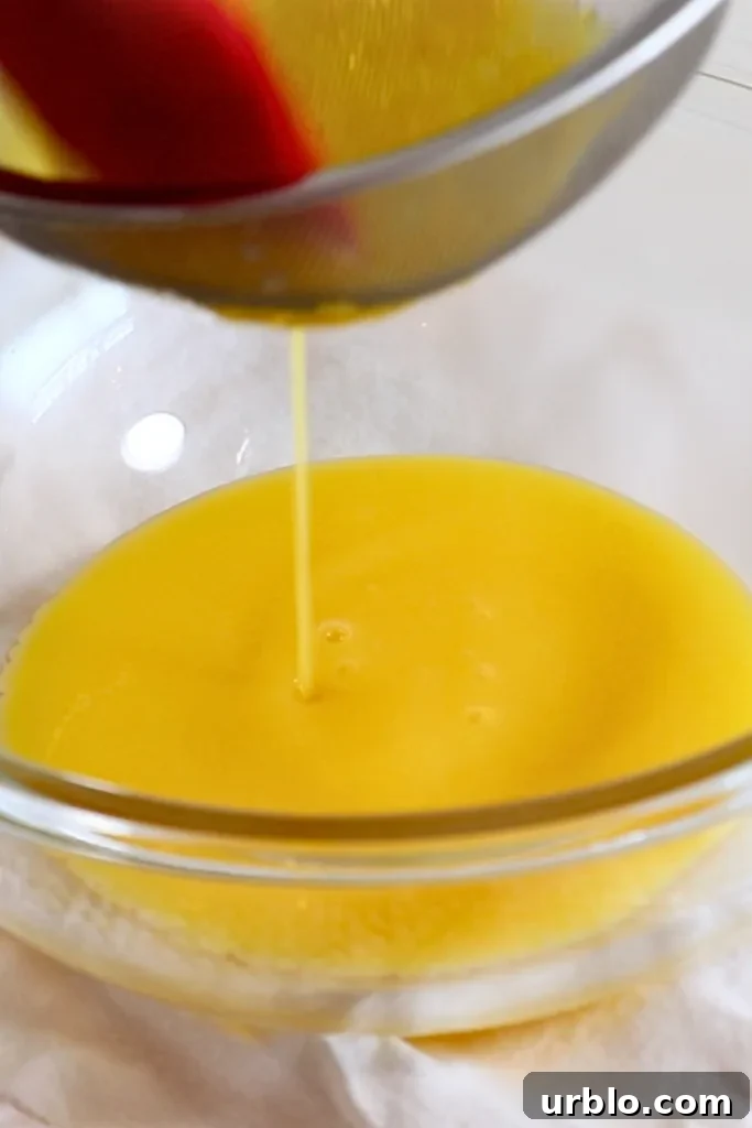 Silky Lemon Mousse Recipe with Fresh Citrus Zest 10 straining the heated yolk and lemon juice mixture into a bowl