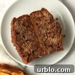 Single Serve Cinnamon Swirl Banana Bread cut in half to show center with a ripe banana.