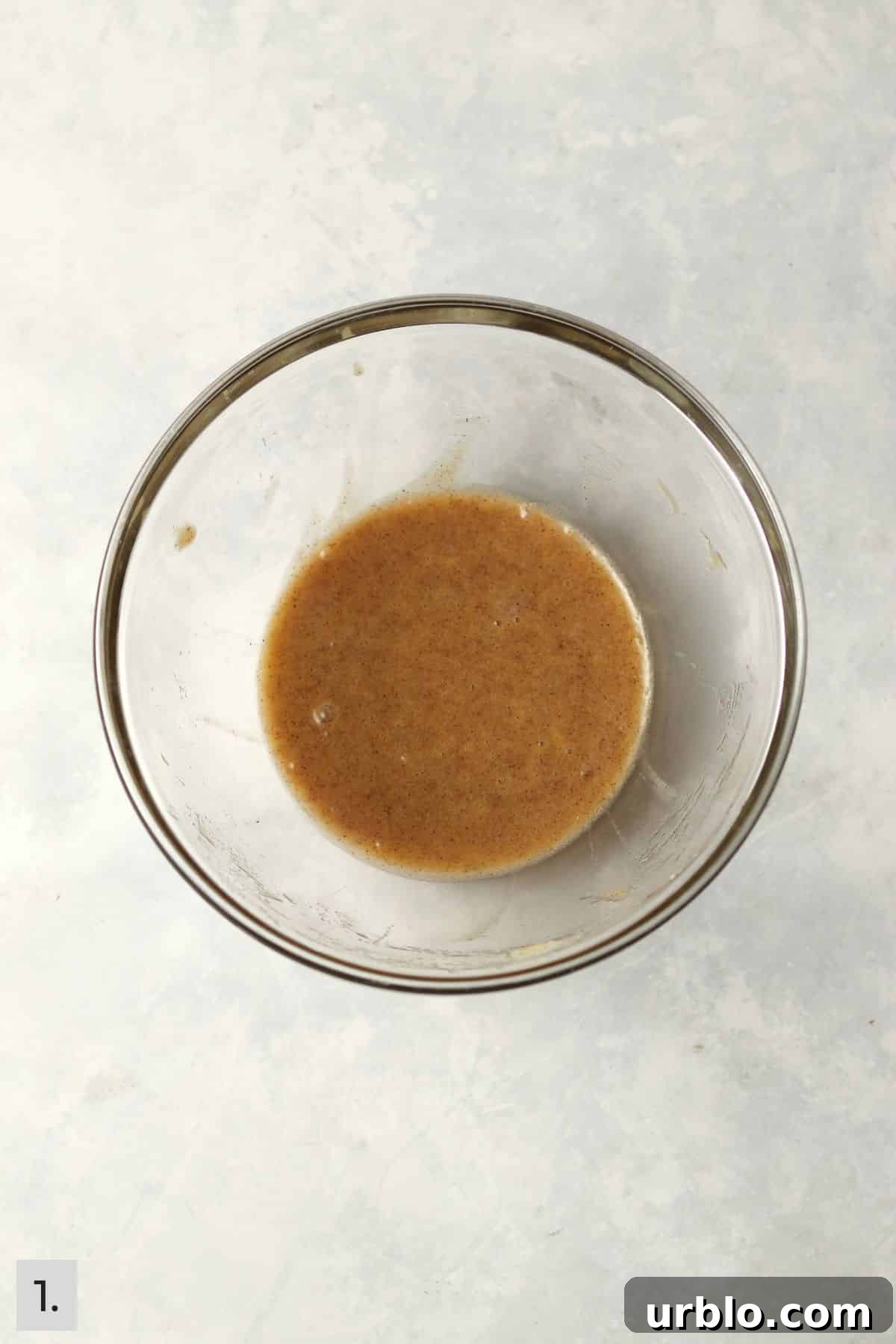 Single-Serve Cinnamon Swirl Banana Bread for One 4 Wet ingredients for banana bread in a glass mixing bowl.