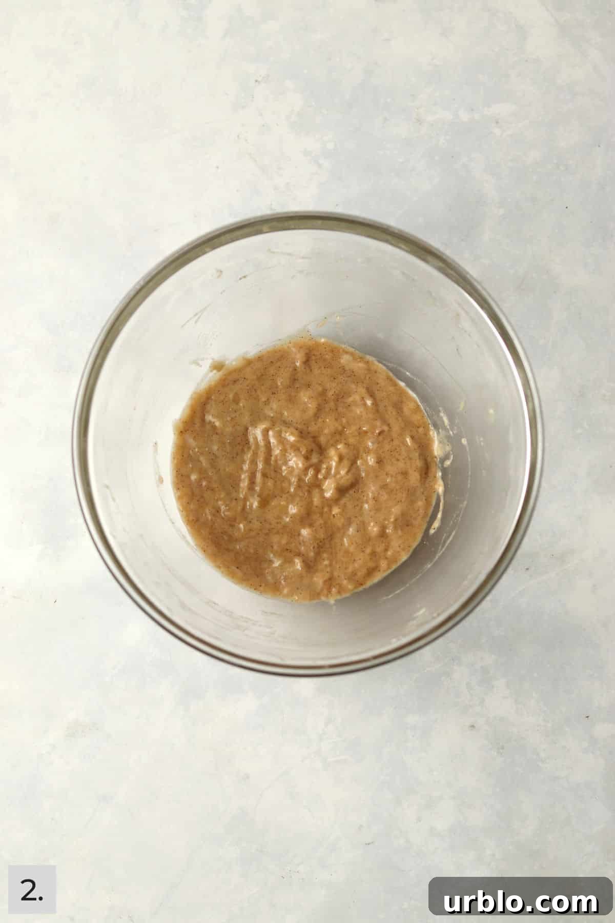 Single-Serve Cinnamon Swirl Banana Bread for One 5 Banana bread batter in a glass mixing bowl.