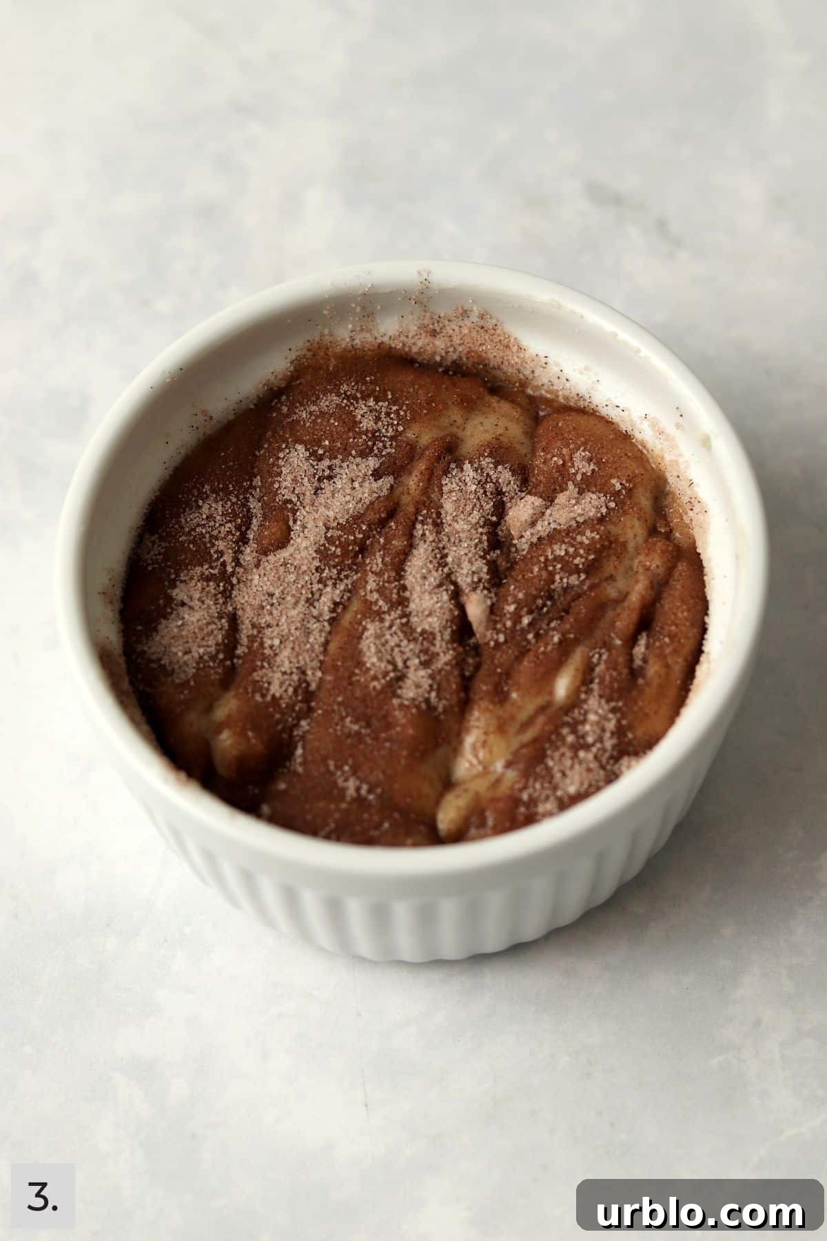 Single-Serve Cinnamon Swirl Banana Bread for One 6 Unbaked single serve cinnamon swirl banana bread in a ramekin.