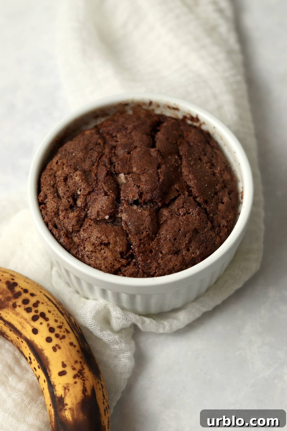 Single-Serve Cinnamon Swirl Banana Bread for One 8 Baked single serve cinnamon swirl banana bread in a ramekin.