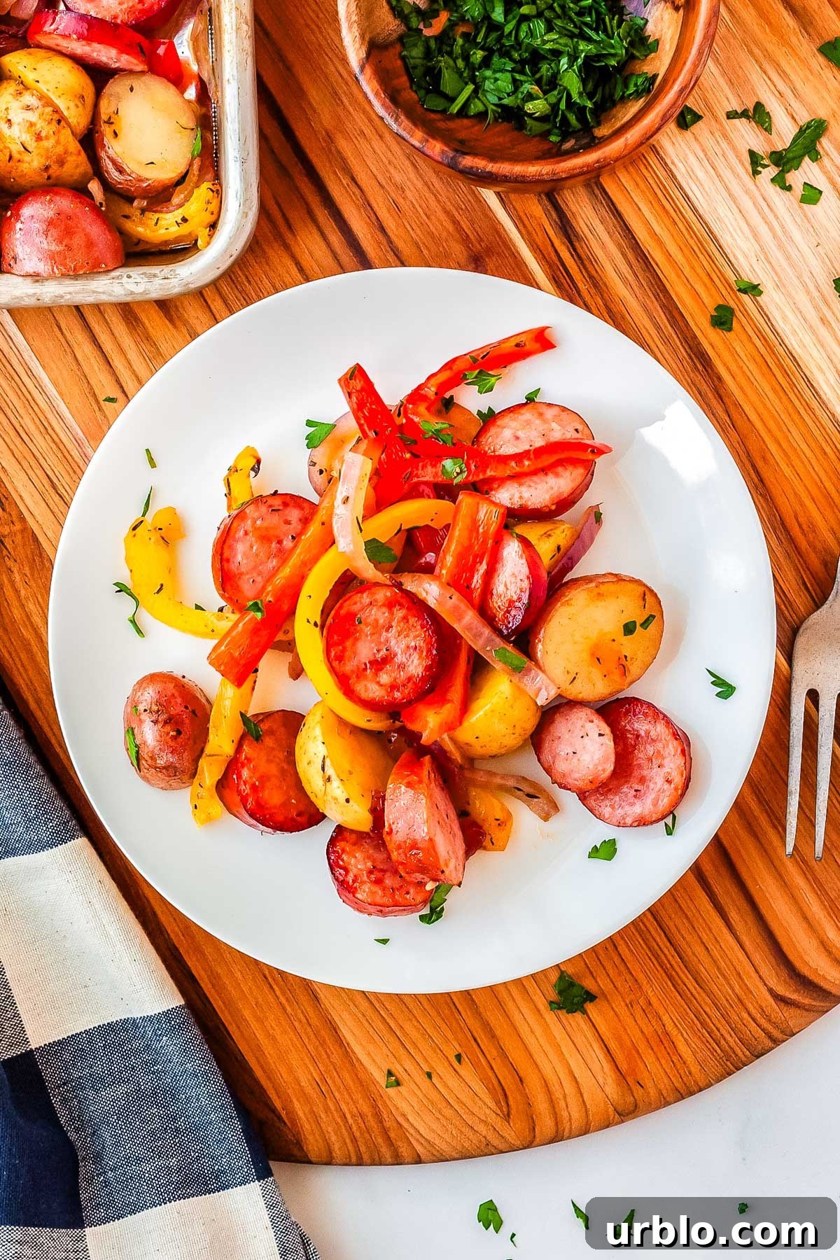 Sheet Pan Smoked Sausage with Roasted Potatoes 9 Sausage and veggies on a white dinner plate.