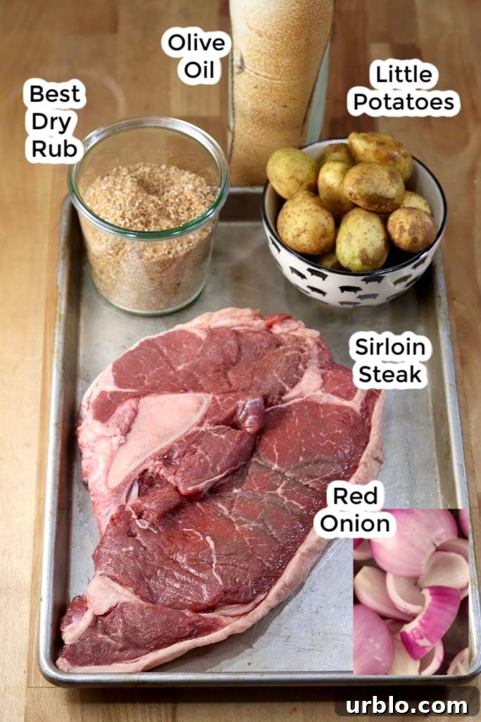 Ingredients for Steak and Potato Kabobs Ingredients for Steak & Potato Kabobs- Sirloin steak, little potatoes, red onion, dry rub, olive oil on a sheet pan with text labels