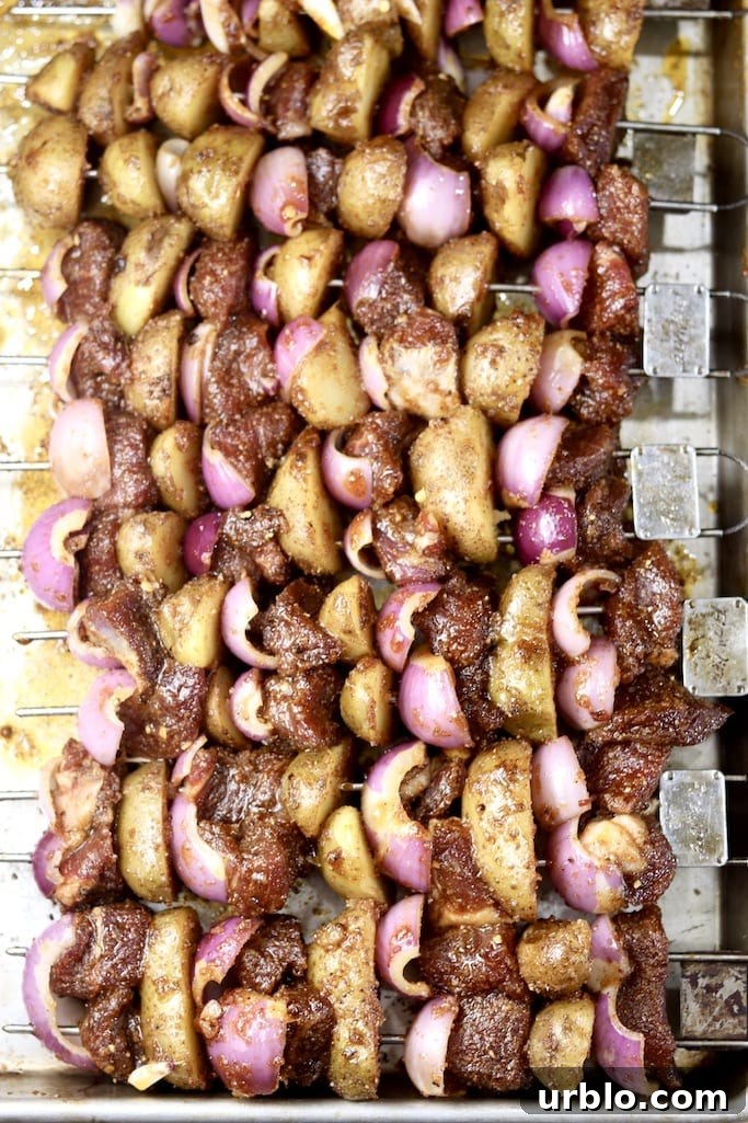 Grilled kabobs with sirloin steak, onions and baby potatoes Grilled steak and potato kabobs on a sheet pan
