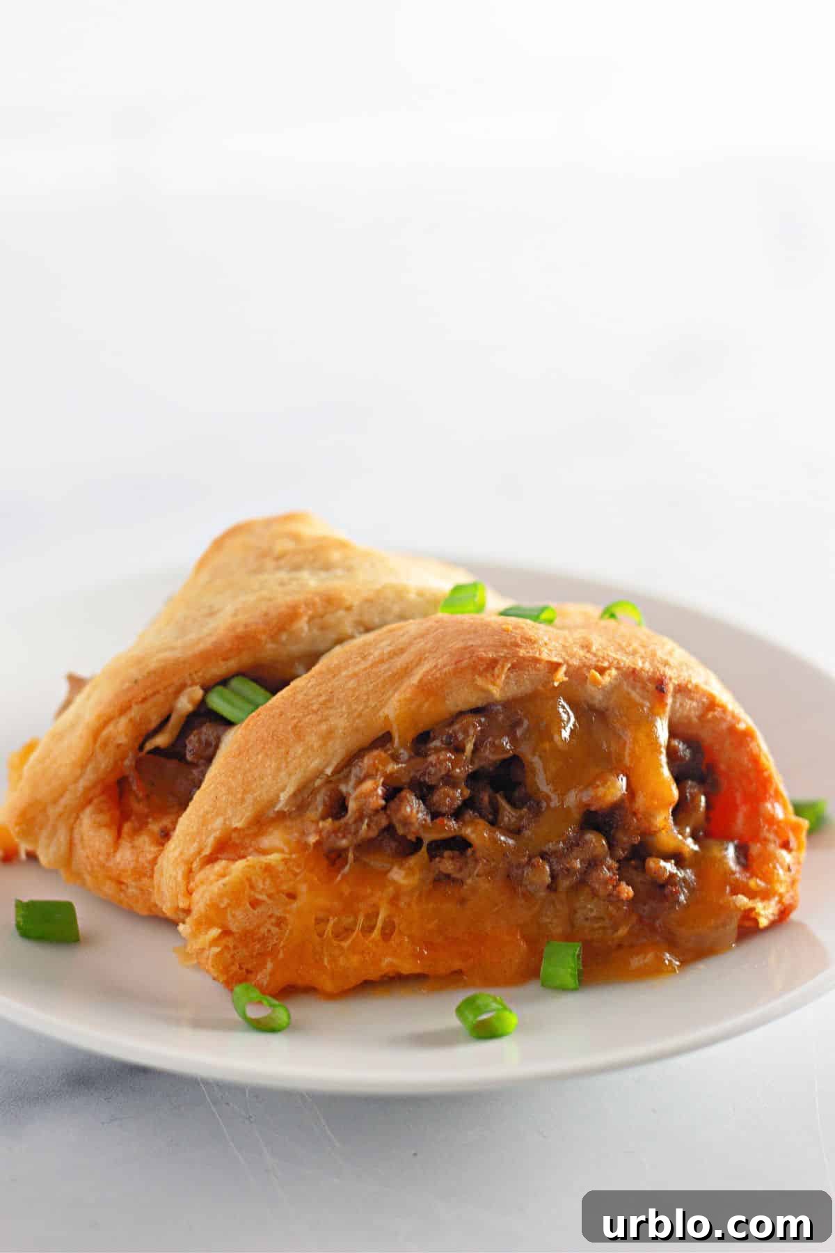 Cheesy Taco Ring with Crescent Roll Crust 3 two slices of taco crescent ring on a plate.