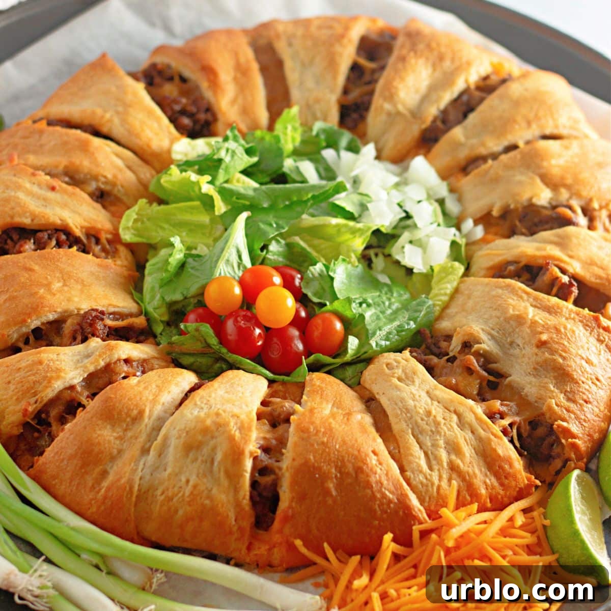 uncut taco crescent ring on a parchment lined baking sheet.