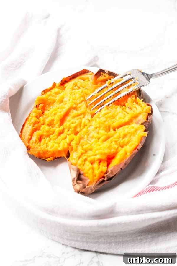 Crispy Baked Sweet Potatoes in the Air Fryer 8 baked sweet potato in Air Fryer on a white plate
