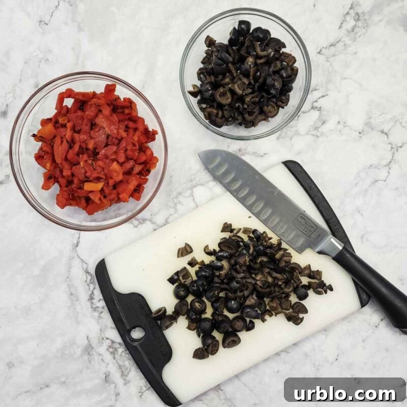 Creamy Ranch Pinwheels with Roasted Red Peppers Appetizer 4 Overhead view of process shot 1 - roughly chop the roasted red peppers and olives.