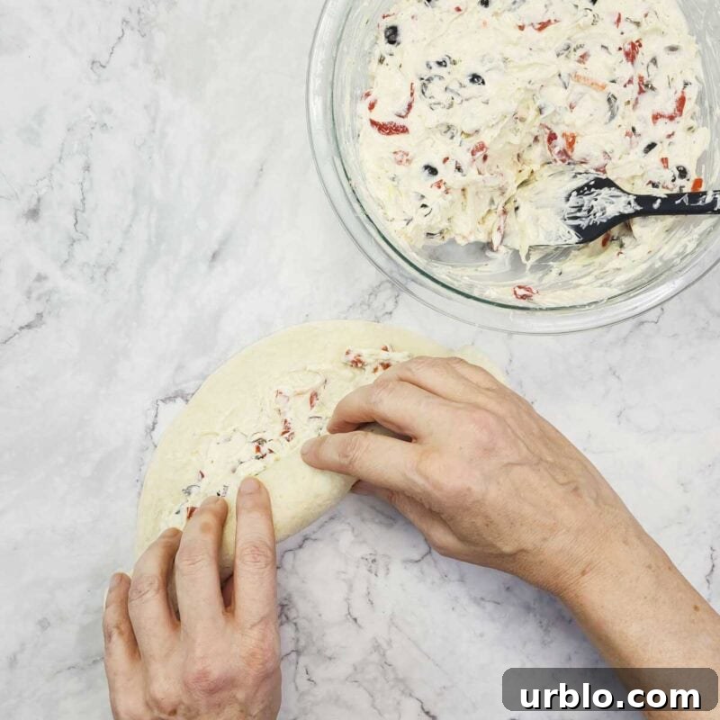 Creamy Ranch Pinwheels with Roasted Red Peppers Appetizer 7 Overhead view of process shot 4 - spread the cream cheese filling over the tortillas. Roll each tortilla as tightly as possible.