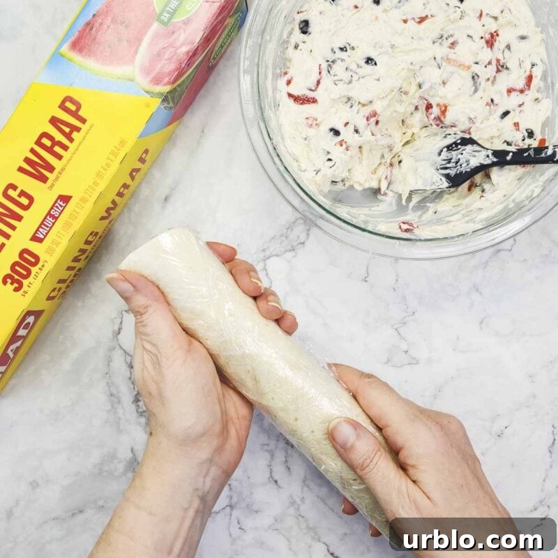 Creamy Ranch Pinwheels with Roasted Red Peppers Appetizer 8 Overhead view of process shot 5 - wrap each tortilla in plastic wrap and refrigerate at least 1-2 hours.